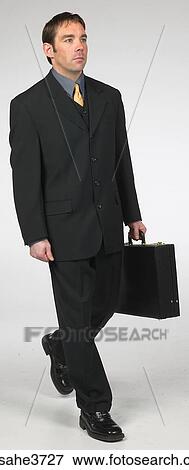 Executive walking with a briefcase View Large Photo Image Stock Photo - Executive walking with a briefcase . Fotosearch