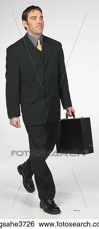 Executive walking with a briefcase View Large Photo Image Stock Photograph - Executive walking with a briefcase . Fotosearch
