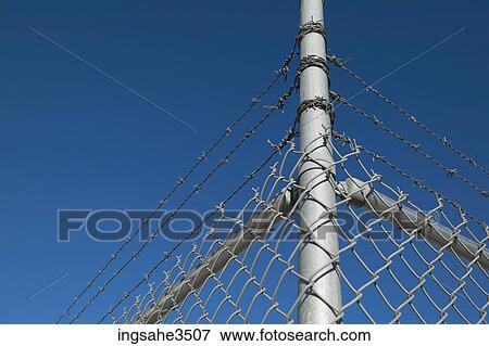 fence topped with barbed wire View Large Photo Image Stock Photo - fence topped with barbed wire . Fotosearch
