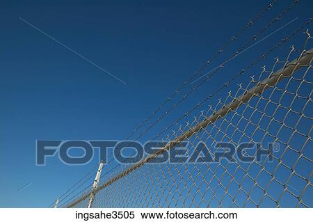 fence topped with barbed wire View Large Photo Image Stock Photography - fence topped with barbed wire . Fotosearch