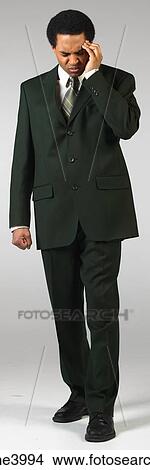 Picture - Grimacing businessman with headache. Fotosearch