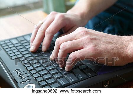 Stock Image - Hands on laptop computer . Fotosearch