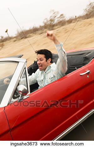 Male young adult driving car View Large Photo Image Stock Image - Male young adult driving car . Fotosearch
