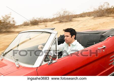 Stock Image - Male young adult driving car . Fotosearch