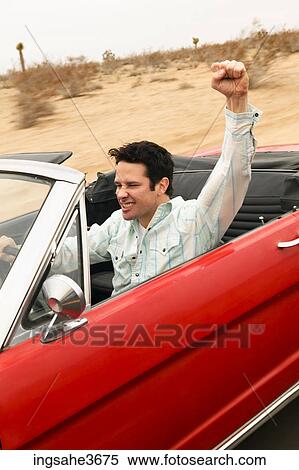 Stock Photography - Male young adult driving car . Fotosearch