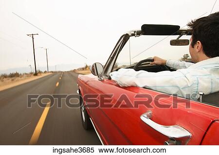 Male young adult driving car View Large Photo Image Stock Photography - Male young adult driving car . Fotosearch