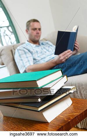 Male young adult sitting in chair View Large Photo Image Stock Photo - Male young adult sitting in chair . Fotosearch