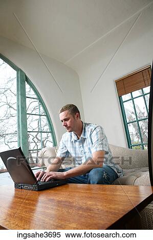 Male young adult sitting on couch View Large Photo Image Stock Photography - Male young adult sitting on couch . Fotosearch