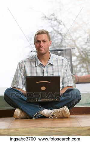 Male young adult sitting on floor View Large Photo Image Stock Image - Male young adult sitting on floor . Fotosearch