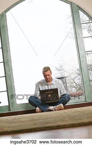 Male young adult sitting on floor View Large Photo Image Stock Image - Male young adult sitting on floor . Fotosearch