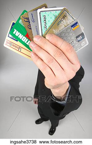 Man holding up credit cards View Large Photo Image Stock Photo - Man holding up credit cards . Fotosearch
