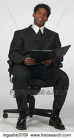 Stock Photo - Man sitting on a chair . Fotosearch