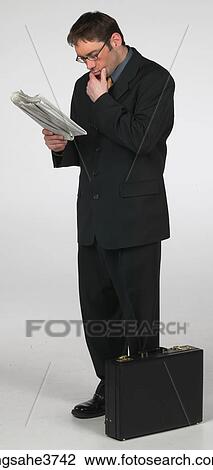 Man standing and reading View Large Photo Image Stock Image - Man standing and reading . Fotosearch