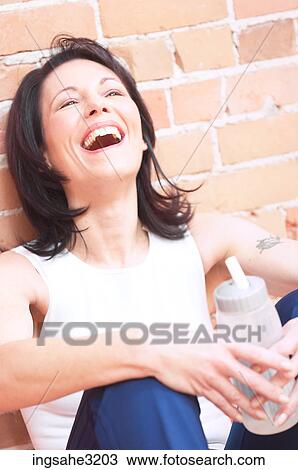 Mature adult woman laughing with water bottle View Large Photo Image Stock Image - Mature adult woman laughing with water bottle . Fotosearch