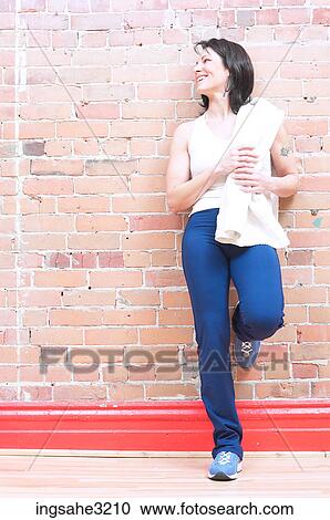 Mature adult woman smiling with water bottle and towel View Large Photo Image Stock Image - Mature adult woman smiling with water bottle and towel . Fotosearch