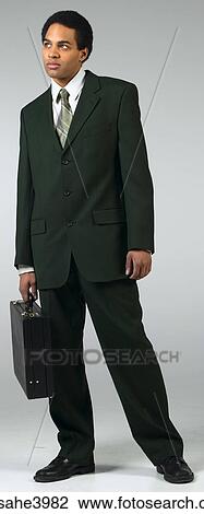 Serious businessman in black suit with briefcase View Large Photo Image Stock Image - Serious businessman in black suit with briefcase . Fotosearch