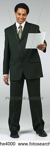 Smiling businessman holding document View Large Photo Image Stock Image - Smiling businessman holding document. Fotosearch