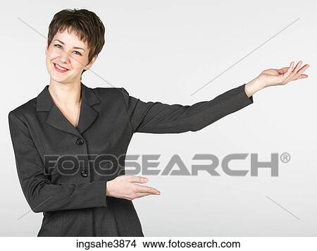 Smiling businesswoman giving presentation View Large Photo Image Picture - Smiling businesswoman giving presentation. Fotosearch