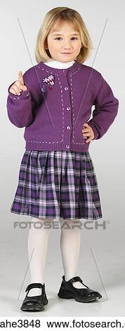Smiling little girl in purple skirt and sweater View Large Photo Image Stock Photo - Smiling little girl in purple skirt and sweater . Fotosearch