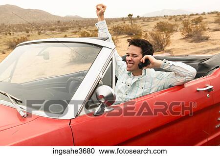 Smiling male young adult driving car View Large Photo Image Stock Image - Smiling male young adult driving car . Fotosearch