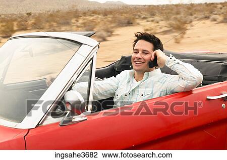 Smiling male young adult driving car View Large Photo Image Stock Image - Smiling male young adult driving car . Fotosearch