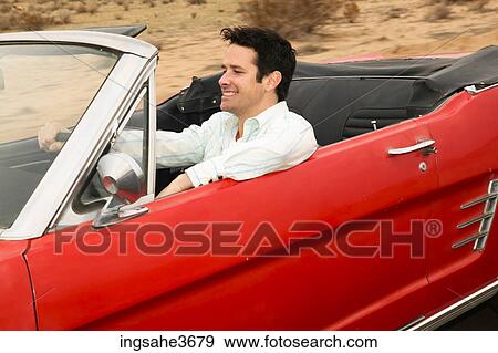 Smiling male young adult driving car View Large Photo Image Stock Photo - Smiling male young adult driving car . Fotosearch