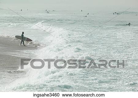 Surfer looking at wave View Large Photo Image Stock Image - Surfer looking at wave . Fotosearch