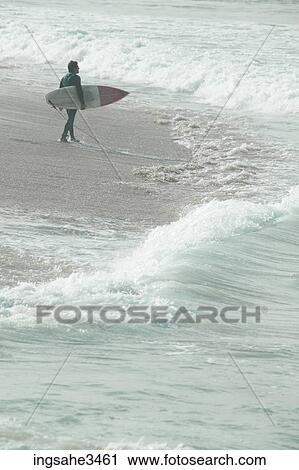 Surfer looking at wave View Large Photo Image Stock Image - Surfer looking at wave . Fotosearch