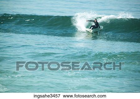 Surfer riding wave View Large Photo Image Stock Photo - Surfer riding wave . Fotosearch