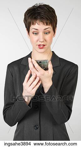 Surprised businesswoman holding PDA View Large Photo Image Picture - Surprised businesswoman holding PDA. Fotosearch