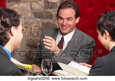Three business people at meeting View Large Photo Image Stock Photograph - Three business people at meeting . Fotosearch