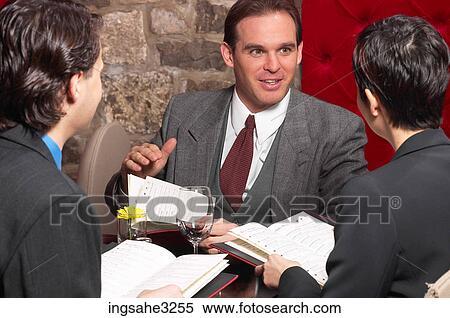 Three business people at meeting with date books View Large Photo Image Stock Photography - Three business people at meeting with date books . Fotosearch
