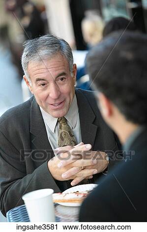 Two business men at lunch talking View Large Photo Image Stock Image - Two business men at lunch talking . Fotosearch