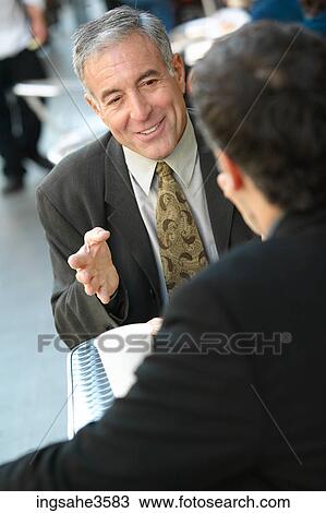 Two business men at lunch talking View Large Photo Image Stock Image - Two business men at lunch talking . Fotosearch