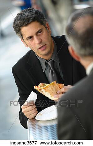 Two business men eating pizza View Large Photo Image Stock Photo - Two business men eating pizza . Fotosearch