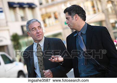 Two business men walking View Large Photo Image Stock Photo - Two business men walking . Fotosearch