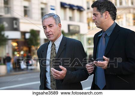 Two business men walking View Large Photo Image Stock Photo - Two business men walking . Fotosearch