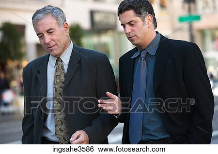 Stock Photograph - Two business men walking . Fotosearch