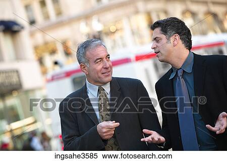 Two business men walking View Large Photo Image Stock Photography - Two business men walking . Fotosearch