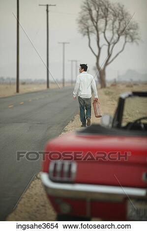 Walking down road with gas can View Large Photo Image Picture - Walking down road with gas can . Fotosearch