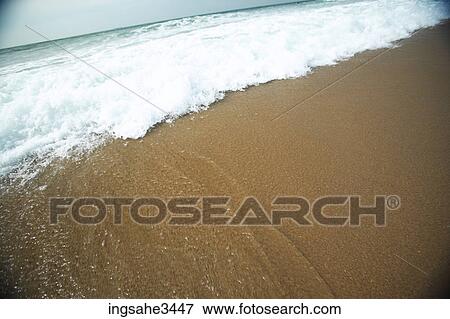 Wave and foam on beach View Large Photo Image Stock Photo - Wave and foam on beach . Fotosearch