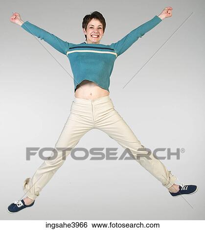 Woman in casual attire jumping View Large Photo Image Stock Photograph - Woman in casual attire jumping. Fotosearch