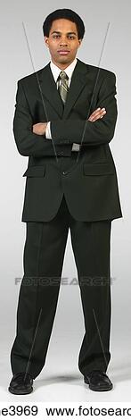 Young African American executive standing with his arms folded View Large Photo Image Stock Photo - Young African American executive standing with his arms folded. Fotosearch