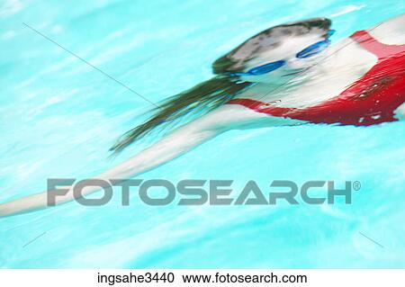 Stock Image - Young female adult swimming . Fotosearch