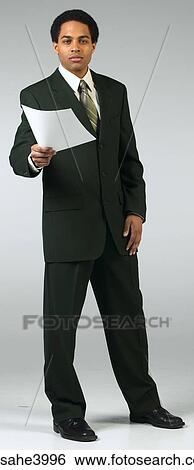 Young man smiling and holding out a memo View Large Photo Image Stock Photograph - Young man smiling and holding out a memo. Fotosearch