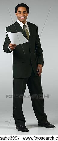 Young man smiling and holding out a memo View Large Photo Image Stock Photo - Young man smiling and holding out a memo . Fotosearch