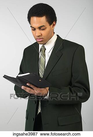 Young man with a organizer View Large Photo Image Stock Photo - Young man with a organizer. Fotosearch