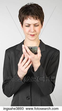 Young woman concentrating on a palm held electronic device View Large Photo Image Stock Image - Young woman concentrating on a palm held electronic device . Fotosearch