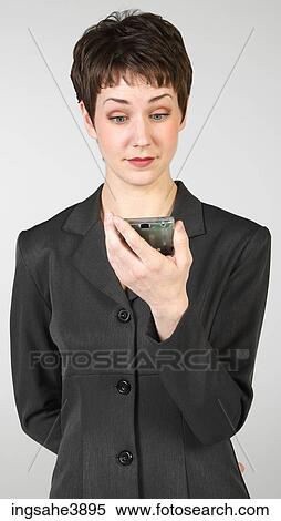 Young woman concentrating on a palm held electronic device View Large Photo Image Stock Photography - Young woman concentrating on a palm held electronic device. Fotosearch