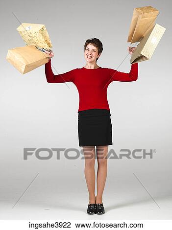Young woman holding a lot of shopping bags View Large Photo Image Stock Image - Young woman holding a lot of shopping bags . Fotosearch